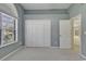Bedroom with carpet, large window, and double closet at 4542 Mandi Ave., Little River, SC 29566