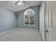 Bedroom with carpet, large window, and double closet at 4542 Mandi Ave., Little River, SC 29566