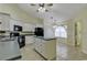 Kitchen with island, white cabinets, and black appliances at 4542 Mandi Ave., Little River, SC 29566