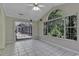 Sunroom with tiled floors and sliding glass doors leading to a screened porch at 4542 Mandi Ave., Little River, SC 29566