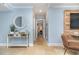 Hallway with light blue walls, white console table, and mirror at 9661 Shore Dr. # B30, Myrtle Beach, SC 29572