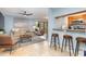Open living space with light blue walls, a comfortable couch, and a kitchen area at 9661 Shore Dr. # B30, Myrtle Beach, SC 29572