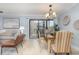 Bright dining room with wooden table, chandelier, and balcony access at 9661 Shore Dr. # B30, Myrtle Beach, SC 29572