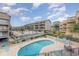 Community pool with lounge chairs and a table at 9661 Shore Dr. # B30, Myrtle Beach, SC 29572