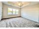 Bright bedroom with plush carpeting, large window, and tray ceiling at 4971 Old State Highway 90, Conway, SC 29526