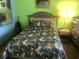 Vibrant bedroom with tropical-themed bedding and nature artwork at 6803 N Ocean Blvd. # 217, Myrtle Beach, SC 29572