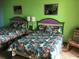 Two beds with tropical print bedding and green walls at 6803 N Ocean Blvd. # 217, Myrtle Beach, SC 29572