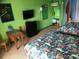 Tropical-themed bedroom with two beds, a table, and a TV at 6803 N Ocean Blvd. # 217, Myrtle Beach, SC 29572