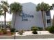 St. John's Inn exterior with palm trees and landscaping at 6803 N Ocean Blvd. # 217, Myrtle Beach, SC 29572