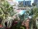 Community pool surrounded by palm trees and lounge chairs at 6803 N Ocean Blvd. # 217, Myrtle Beach, SC 29572