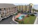 Aerial view of a beachfront condo complex with pool and parking at 202 75Th Ave N # 5702/5703, Myrtle Beach, SC 29572