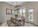 Bright dining room with farmhouse table and bench, showcasing a view to the backyard at 5451 Shelly Lynn Dr., Myrtle Beach, SC 29579