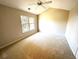 Spacious carpeted bedroom with large window and ceiling fan at 107 Pawleys Place Dr. # 107, Litchfield, SC 29585