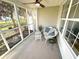 Cozy screened porch with seating area, perfect for relaxing at 107 Pawleys Place Dr. # 107, Litchfield, SC 29585