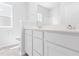 Modern bathroom with white cabinets, quartz countertop, and a double vanity at 1127 Nw Rosefield Way, Calabash, NC 28467