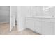 Elegant bathroom with double vanity, a toilet, and a walk-in closet at 1127 Nw Rosefield Way, Calabash, NC 28467
