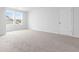 Well-lit bedroom with neutral carpeting and a window at 1127 Nw Rosefield Way, Calabash, NC 28467