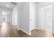 Bright hallway with hardwood floors and access to other rooms at 1127 Nw Rosefield Way, Calabash, NC 28467