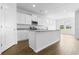 Open concept kitchen with white cabinets, an island, and a breakfast nook at 1127 Nw Rosefield Way, Calabash, NC 28467