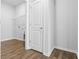 Laundry room with wood flooring, shelving and a door at 1127 Nw Rosefield Way, Calabash, NC 28467