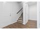 Carpeted staircase with wooden flooring and access to other rooms at 1127 Nw Rosefield Way, Calabash, NC 28467