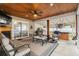 Cozy screened porch with fireplace, seating area, and patio doors at 119 Clemson Rd., Conway, SC 29526