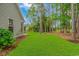 House exterior and backyard with green grass and trees at 1226 Foxtail Dr., Longs, SC 29568