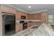 Modern kitchen with granite countertops and black appliances at 1226 Foxtail Dr., Longs, SC 29568