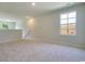 Spacious loft area with neutral carpeting and window at 1333 Palm Springs Paloma Dr, Longs, SC 29568