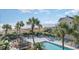 Relaxing pool area with ocean view, palm trees, and beach access at 1501 Waccamaw Dr. # 3-L, Murrells Inlet, SC 29576