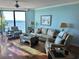 Spacious living room with ocean views, hardwood floors and comfortable seating at 1990 N Waccamaw Dr. # 1209, Garden City Beach, SC 29576