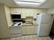 Small condo kitchen with white cabinets and appliances at 201 S Ocean Blvd. # 714, Myrtle Beach, SC 29577