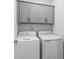 Laundry room with washer, dryer and upper cabinets at 228 Averyville Dr., Conway, SC 29526