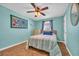 Bright bedroom with a single bed, ceiling fan, and wood floors at 310 34Th Ave. N, North Myrtle Beach, SC 29582