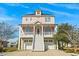 Two-story house featuring a charming pink exterior and two-car garage at 338 Harbour View Dr., Myrtle Beach, SC 29579