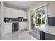 Small kitchen with white cabinets, wine cooler, and backyard access at 338 Harbour View Dr., Myrtle Beach, SC 29579