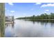 Scenic view of calm water with docked boats and lush trees at 338 Harbour View Dr., Myrtle Beach, SC 29579