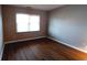 Simple bedroom with wood-look floors and large window at 425 Spauldingwood Rd., Little River, SC 29566