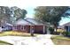 Brick ranch home with red shutters, driveway, and landscaping at 425 Spauldingwood Rd., Little River, SC 29566