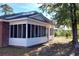 White sided home with a large screened porch at 425 Spauldingwood Rd., Little River, SC 29566