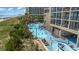 Large resort pool area with multiple pools and plenty of lounge chairs at 4800 Ocean Blvd. S # 915, North Myrtle Beach, SC 29582