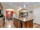 Spacious kitchen with island, dark wood cabinets, and tile flooring at 5373 Highway 66, Loris, SC 29569