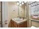 Clean bathroom with single sink vanity, shower/tub combo and linen storage at 6001 - P-29 S Kings Hwy., Myrtle Beach, SC 29575