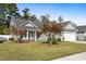 Gray house with white garage door, stone accents, and landscaping at 629 Chiswick Dr., Conway, SC 29526