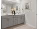 Modern double vanity bathroom with gray cabinets and quartz countertops at 7065 Watercress St, Myrtle Beach, SC 29579