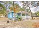 Cute blue house with a white porch, landscaping, and large trees at 712 34Th Ave. S, North Myrtle Beach, SC 29582