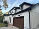 Side view of the house highlighting the garage and exterior details at 828 Channel Cat Cove, Murrells Inlet, SC 29576