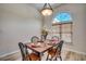 Dining room with wooden table and four chairs, and an arched window at 9 Bear Creek Loop, Murrells Inlet, SC 29576