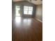 Spacious living room featuring laminate wood flooring and a large window at 9804 Conifer Ln., Murrells Inlet, SC 29576