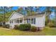 Ranch style home with green shutters, landscaping, and a welcoming front porch at 1002 Palmer Dr., Calabash, NC 28467